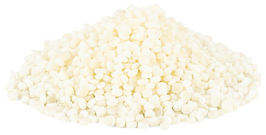 A pile of cream tinted NonOilen granules isolated on the white background.